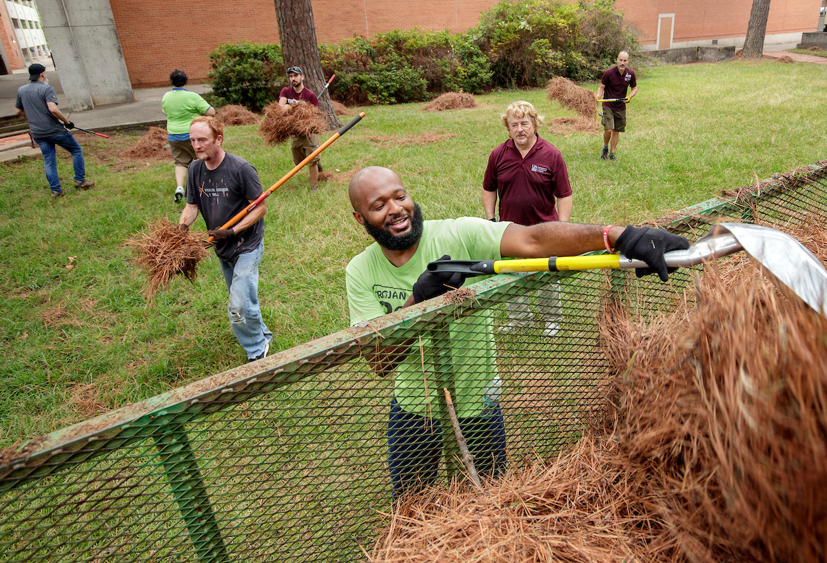 Information Technology Services staff members volunteer their time to help landscape and cleanup parts of campus. Photo by Ben Krain.