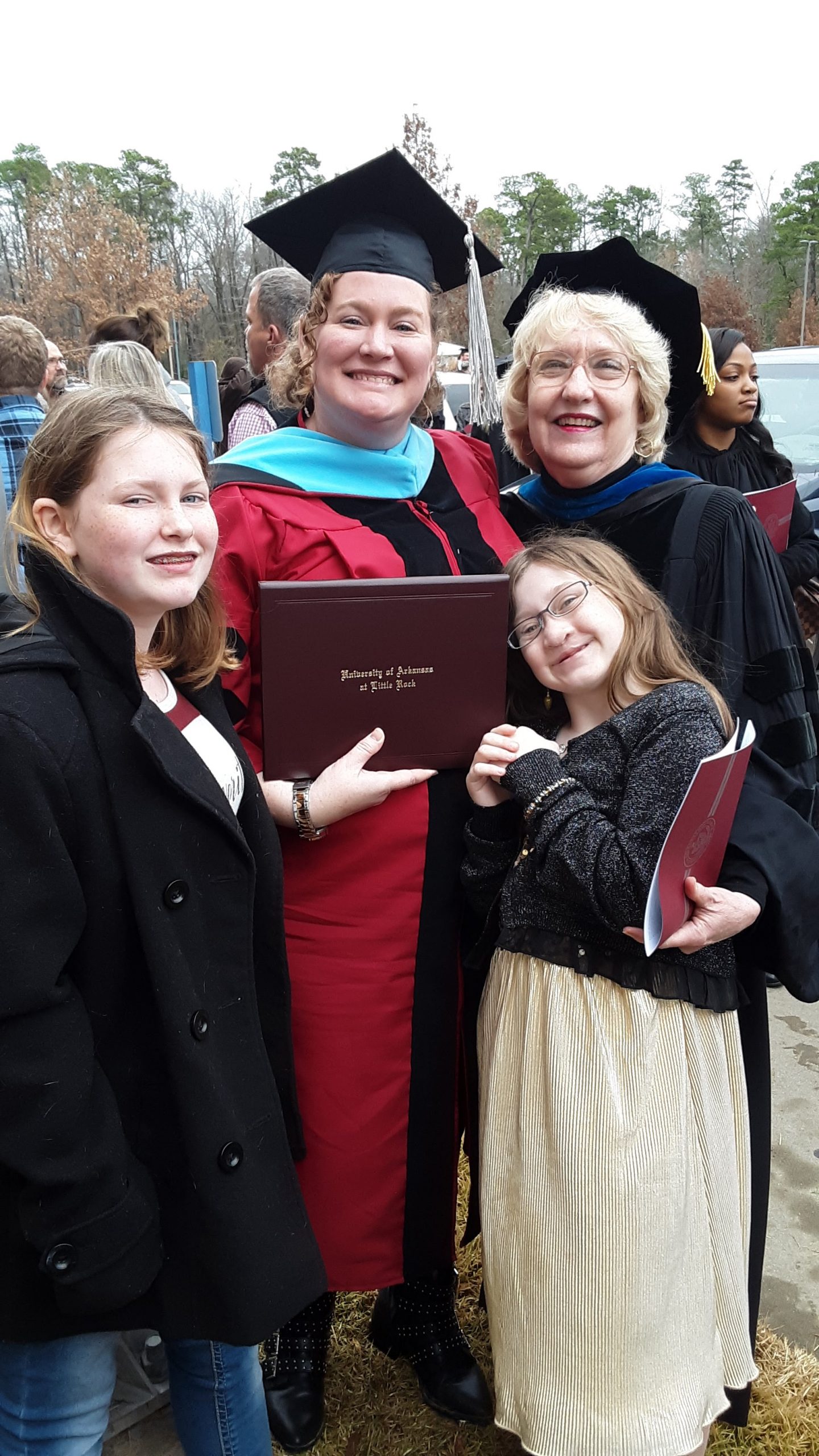 Dr. Ann Robinson celebrates the graduation of Dr. Monica Meadows with her daughters.