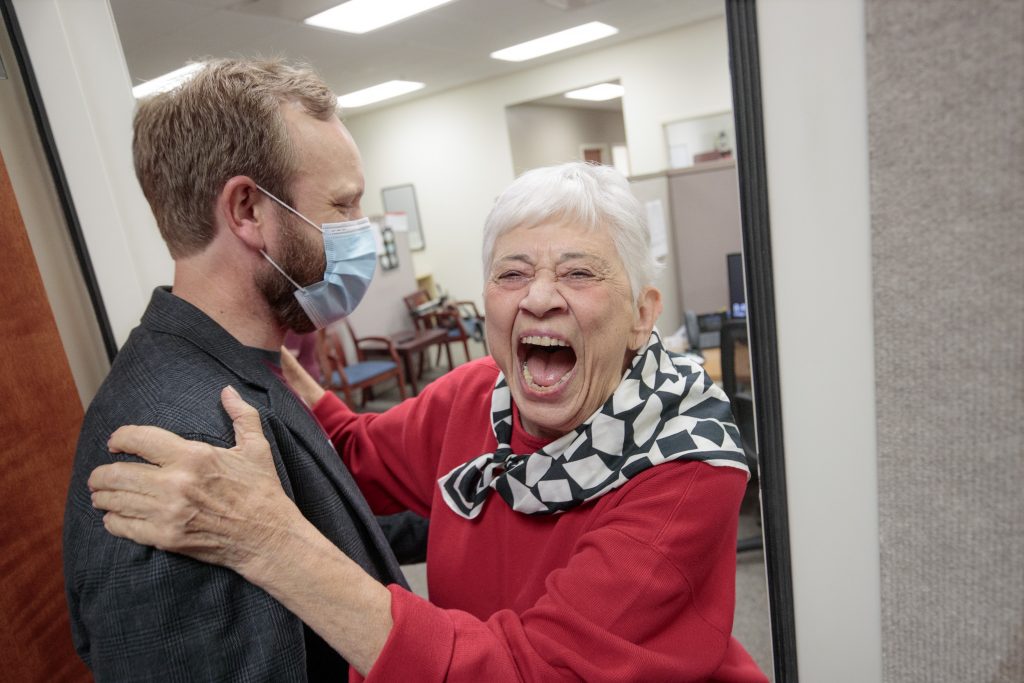 Mary Waldo, a former KUAR staff member, right, reacts in joy with UA Little Rock Public Radio General Manager Nathan Vandiver, left, after learning of a $1.5 million dollar gift to the station. Photo by Ben Krain. 