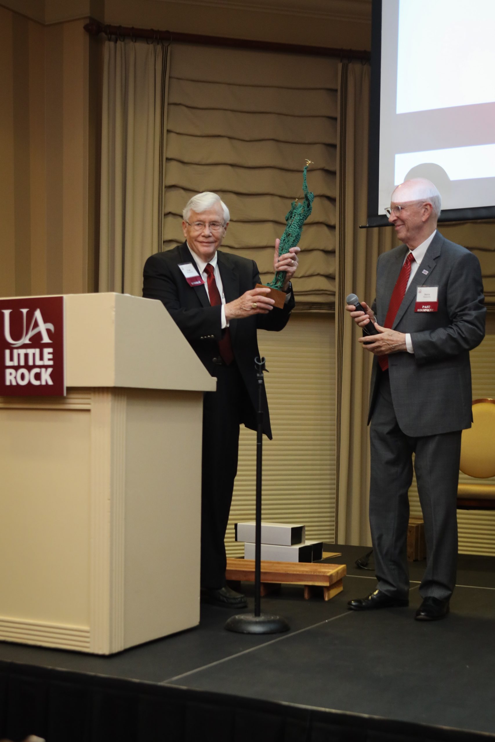 Jerry Damerow presents Carl Rosenbaum with the 2021 Fribough Award from UA Little Rock. Photo by Jen Missouri Photography.