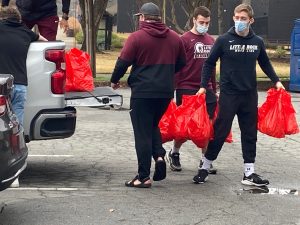 Wrestling student-athletes take donated hams to Every Arkansan.