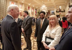 Governor Asa Hutchinson congratulates Mariya Khodakovskaya and other Arkansas Research Alliance Academy of Scholars and Fellows members during a ceremony honoring her and 7 other new inductees.