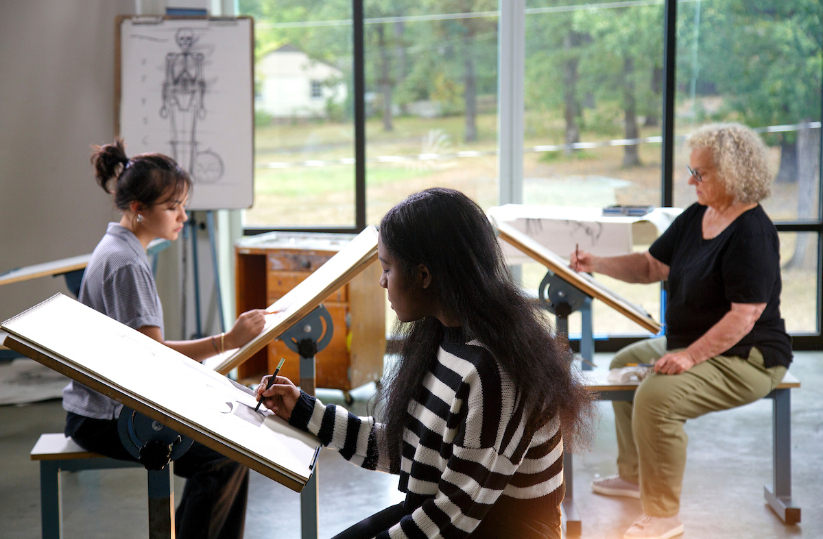 Students pose for a scene in the Expect More tv commercial during a drawing and painting class at the Windgate Center for Art and Design.