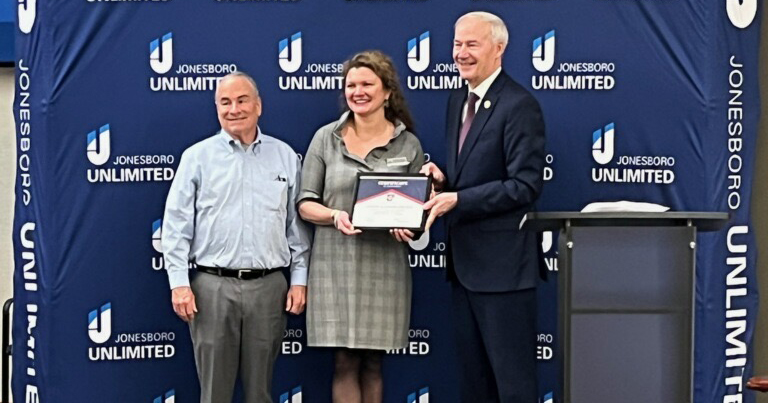 Gov. Asa Hutchinson, right, presents Dr. Albert Baker, left, chair of the Department of Computer Science at UA Little Rock, and Dr. Erin Finzer, center, associate vice chancellor for academic affairs at UA Little Rock, with a certificate honoring their recent workforce development grant by the Arkansas Office of Skills Development.