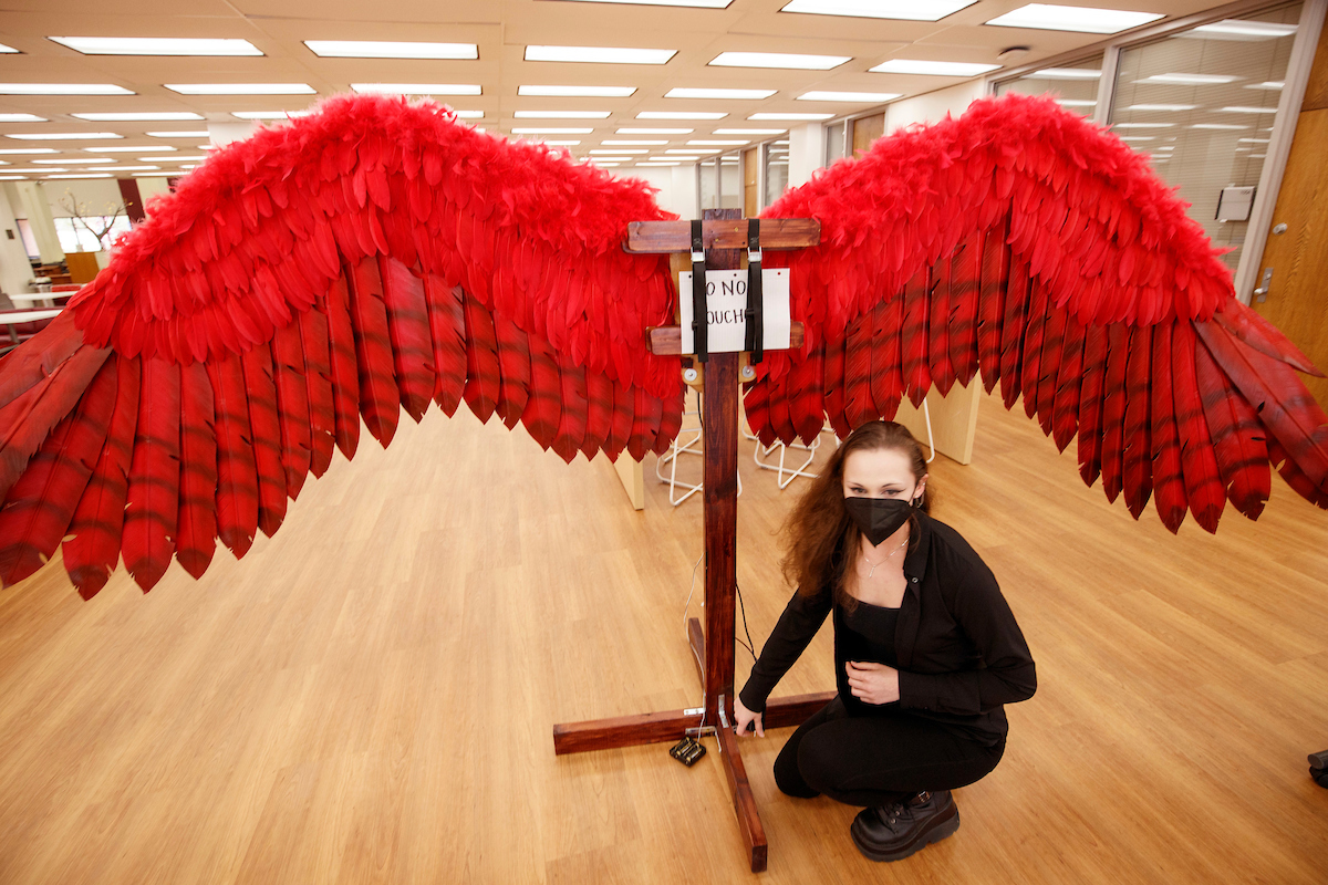 Physics major Meagan Herbold exhibits her mechanical wings engineered with foam feathers during the 2022 Student Research and Creative Works Expo.