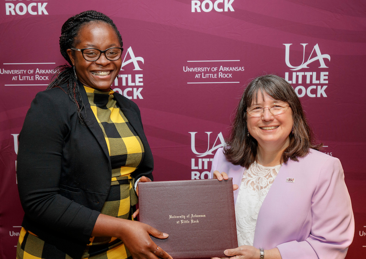 Josy Nduku receives the CBHHS Faculty Excellence Award in Teaching from Chancellor Christina Drale.