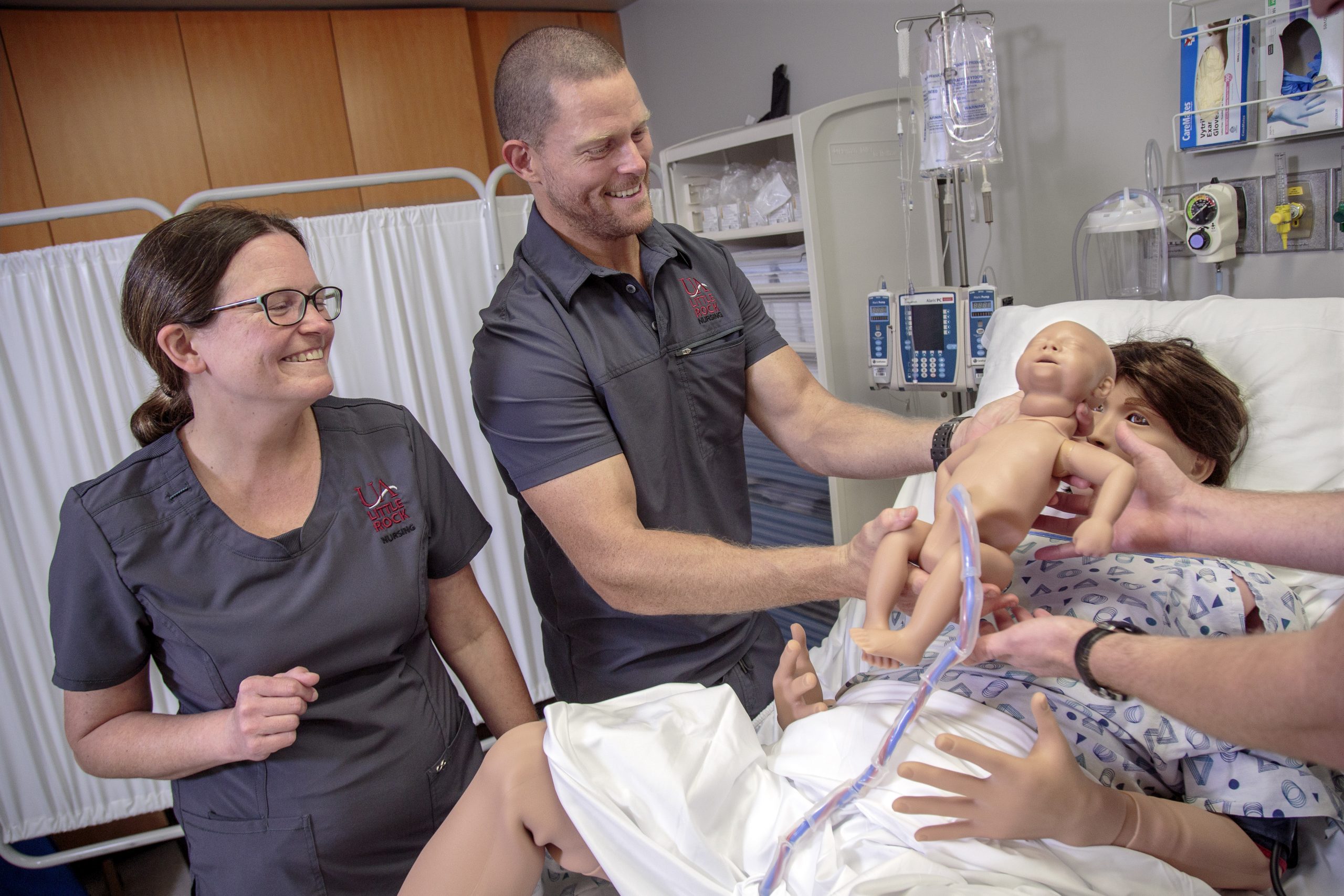 UA Little Rock nursing students deliver a baby on the School of Nursing's new Lucina AR Childbirth Simulator. Photo by Ben Krain.