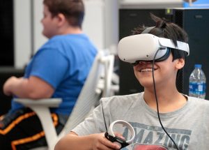 Middle and high school students creating immersive games for the Meta Quest Virtual reality platform during a VR camp for youth at UA Little Rock.