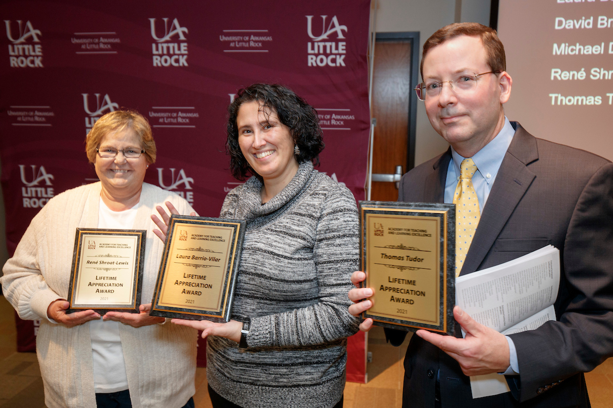 ATLE Co-Directors René Shroat-Lewis, Laura Barrio-Vilar, and Tom Tudo receive awards during the Faculty Excellence Awards Ceremony. Photo by Ben Krain.