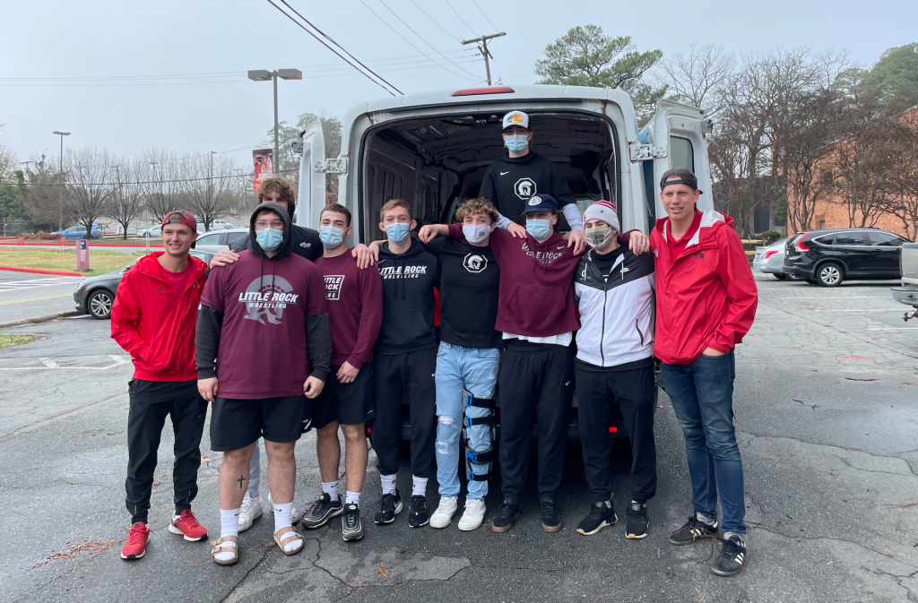 Members of the Little Rock Wrestling team load donated hams up for Every Arkansan.