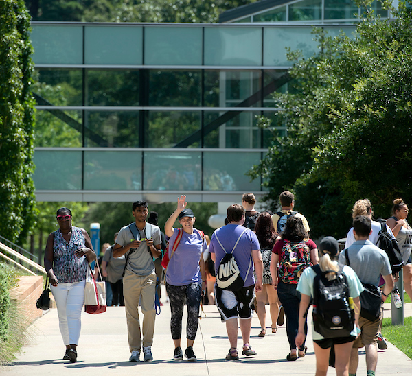 UA Little Rock students walk to class on a beautiful day.