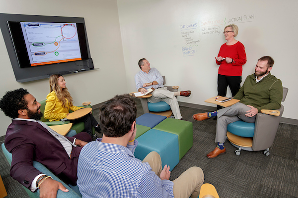 State Director Laura Fine leads a team meeting at the Arkansas Small Business and Technology Development Center at UA Little Rock. Photo by Ben Krain.
