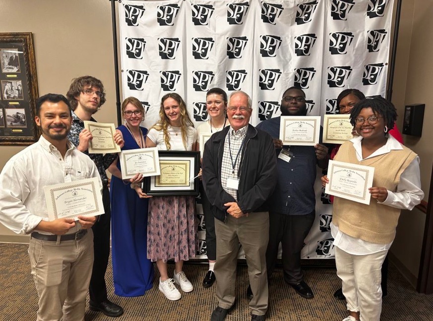 UA Little Rock student journalists are shown holding their awards from the annual Arkansas College Media Association award competition.