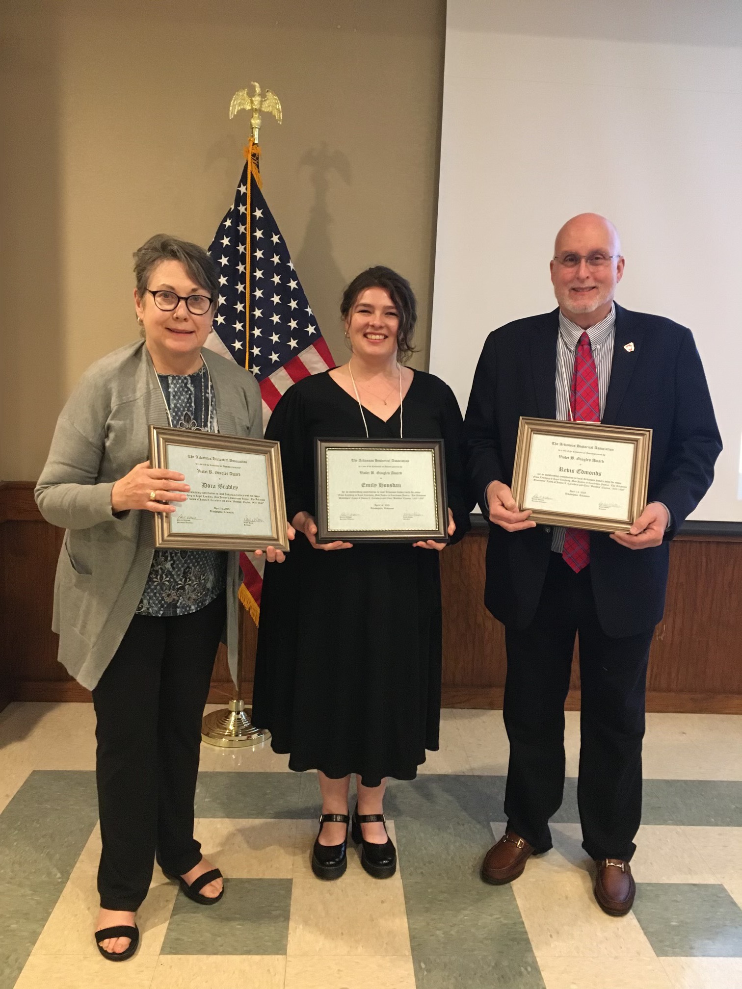 UA Little Rock students Dora Bradley, Emily Housdam, and Revis Edmonds receive the Gingles Award from the Arkansas Historical Association.