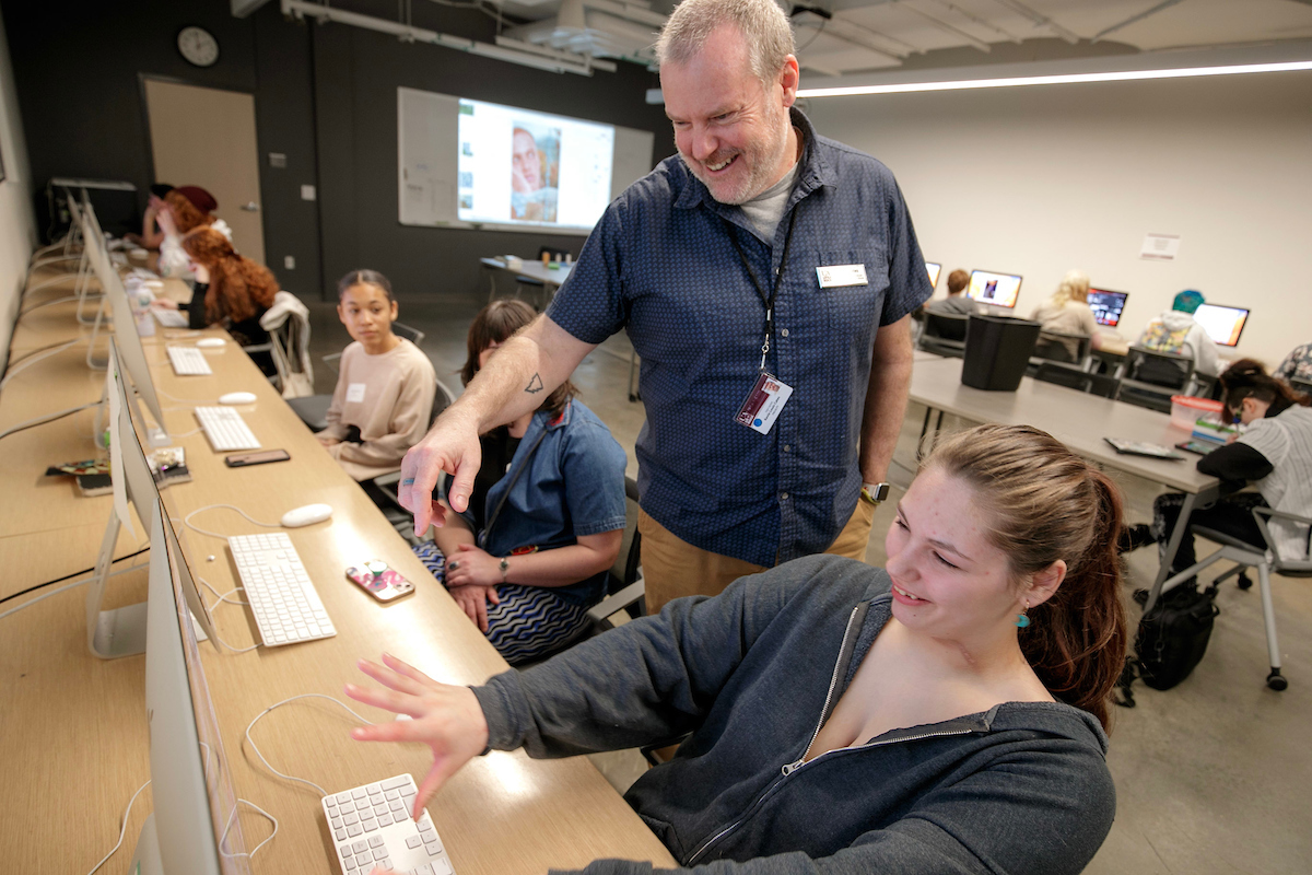 Professor Kevin Cates teaches students during a graphic design class at UA Little Rock.
