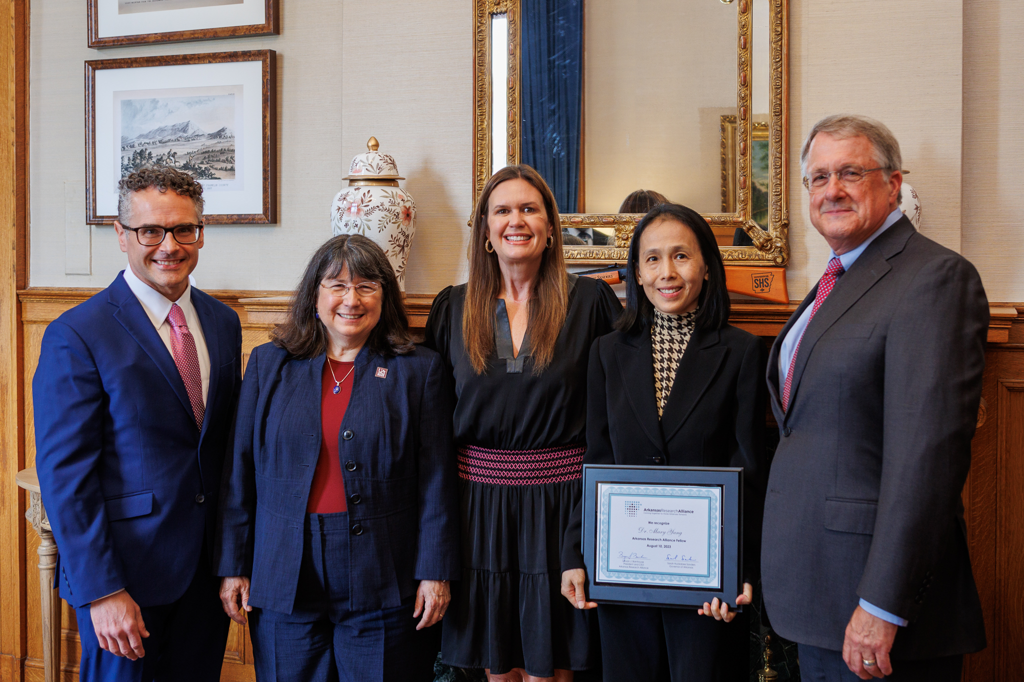 Dr. Mary Yang is inducted into the Arkansas Research Alliance Academy. She is shown with ARA President and CEO Bryan Barnhouse, Chancellor Christina Drale, Governor Sarah Huckabee Sanders, and ARA Chairman Ritter Arnold. Photo by Focus 501.