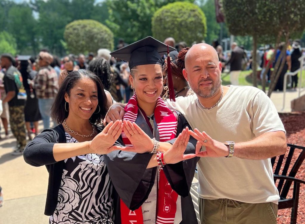 Nyah Peyton celebrates her May 2023 graduation from UA Little Rock with her parents at the Jack Stephens Center.