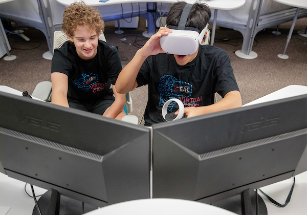 Two middle school students attend a virtual reality summer camp at UA Little Rock. Photo by Ben Krain.