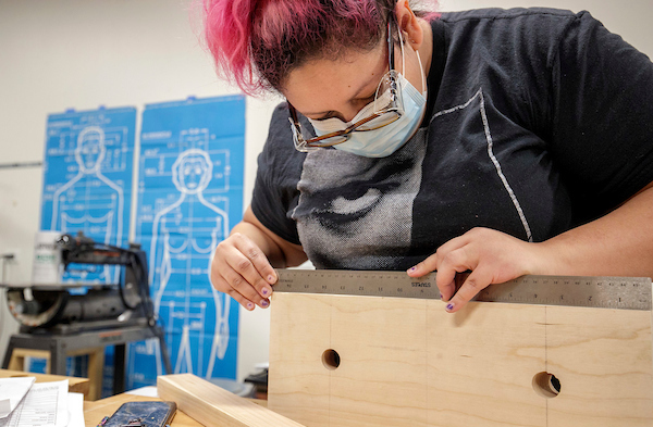 Kim Arcega works on a wordworking project in the Windgate Center of Art and Design. Photo by Ben Krain.