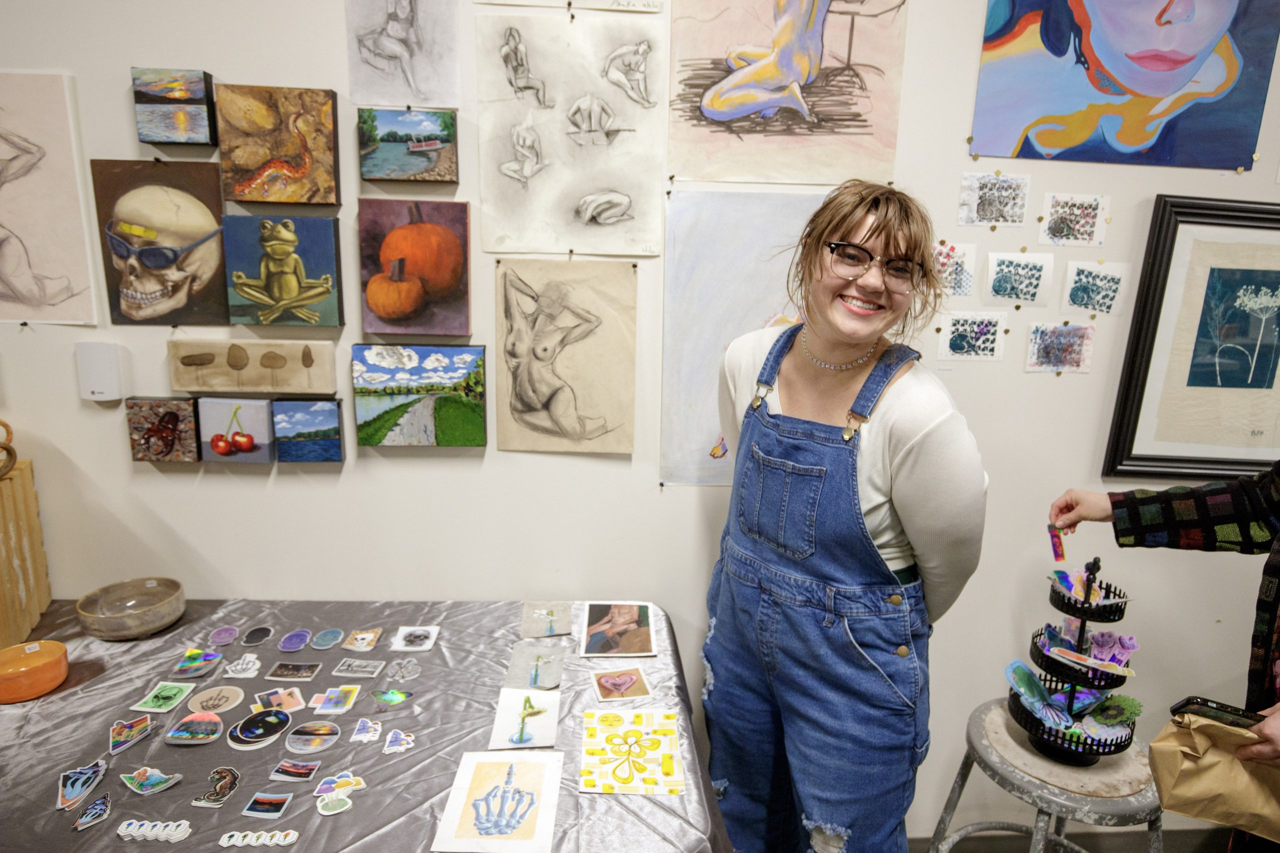 UA Little Rock Student displaying her art during the Holiday Art Sale.