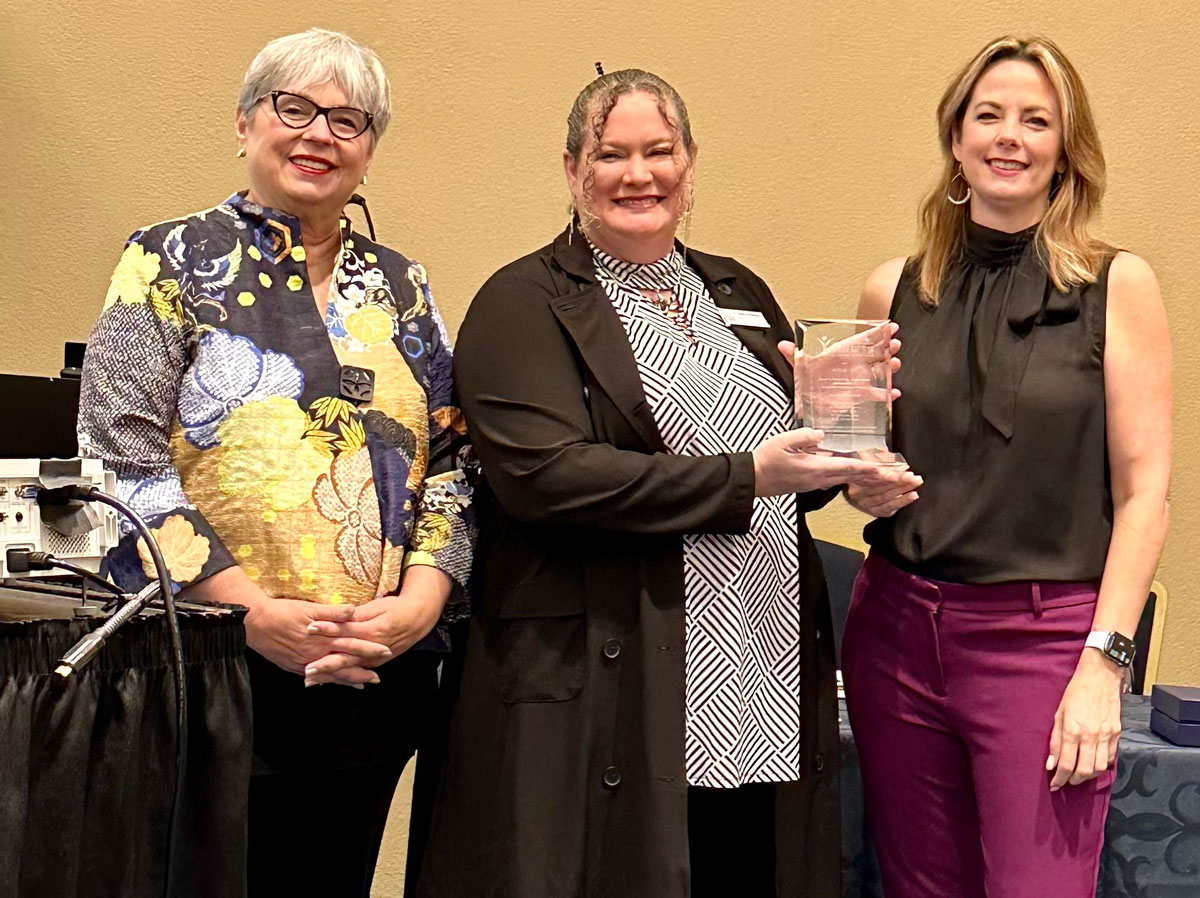 Jodie Mahony Center for Gifted Education associates Christine Deitz, left, and Monica Meadows, center, receive the award from NAGC Professional Learning Network Chair-elect Kim Stephenson, right.
