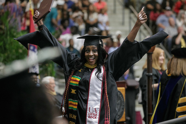 Graduating students participate in the Spring 2023 Commencement Ceremony in the Jack Stephens Center. Photo by Benjamin Krain.