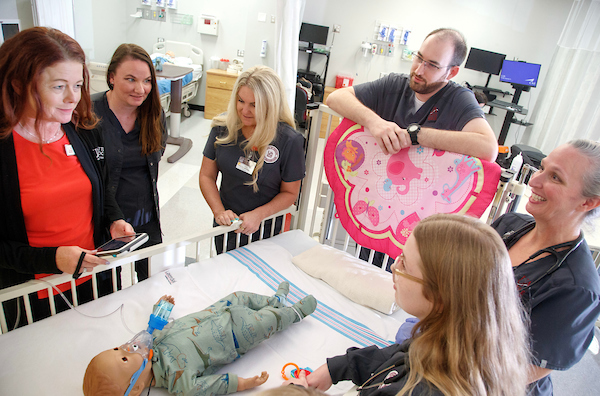 Dr. Sloan Davidson, director of the School of Nursing at UA Little Rock, leads a group of nursing students through a simulation in the Center for Simulation Innovation. Photo by Ben Krain.