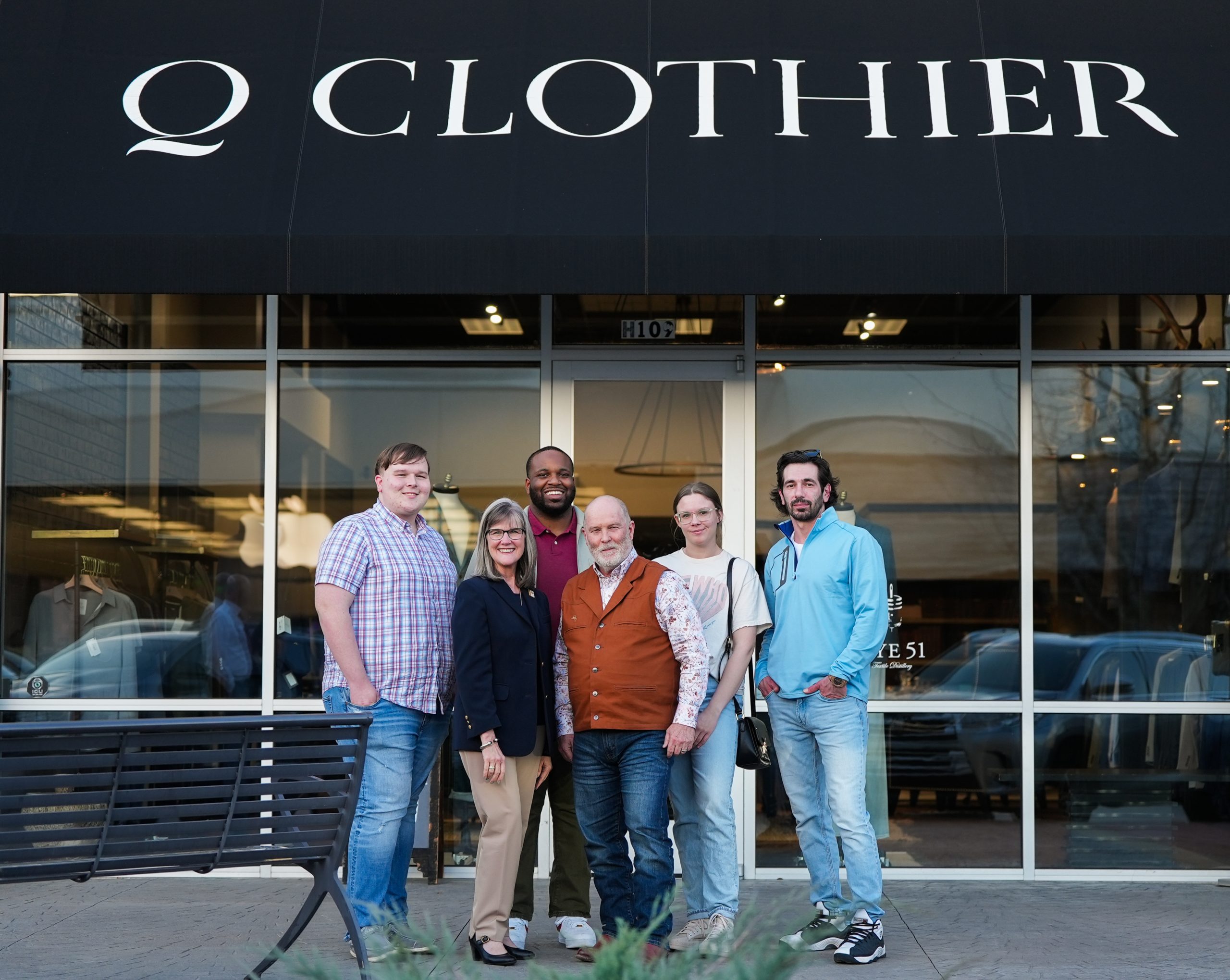 Paul Rainwater (center), owner of Q Clothier, has donated his time and talents to create custom business outfits for UA Little Rock students competing in a national real estate competition. The people include, from left to right, Adison Cummings, Elizabeth Small, Lamar Townsend, Paul Rainwater, Ashlin Graveline, and Osman Bagandov. Photo by Ahmed Elkhattabi.