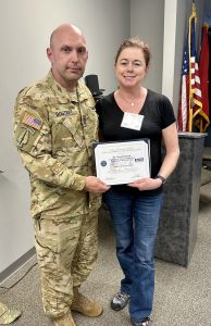Dr. Sloan Davidson receives the Patriotic Employer Award from the Employer Support of the Guard and Defense from Sergeant First Class Brandon Dostert. 