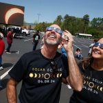 Visitors to UA Little Rock watch the total solar eclipse on April 8 at the Jack Stephens Center. Photo by Benjamin Krain.