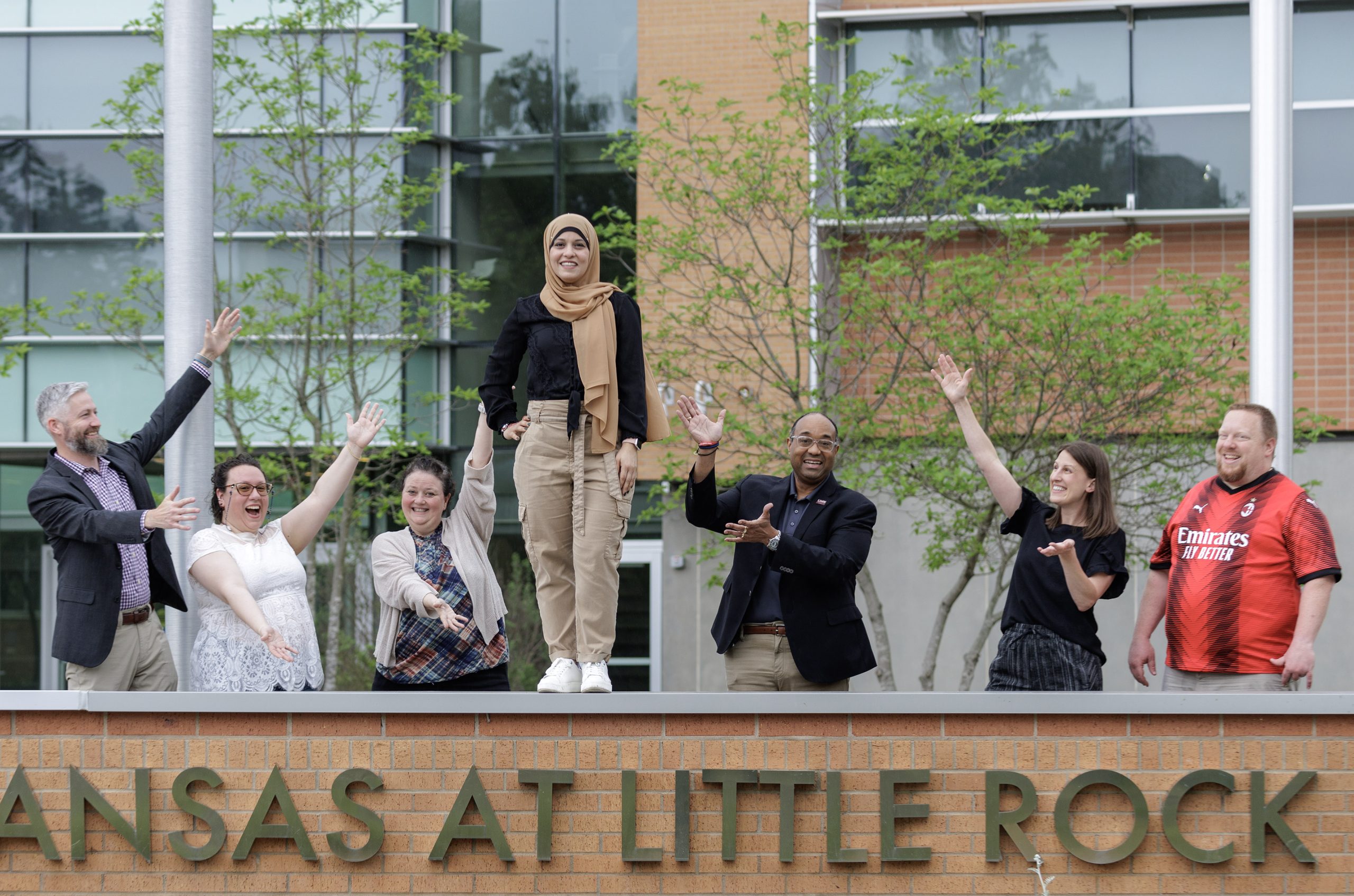 Graduating Doctoral Student Ronia Kattoum is surrounded by her colleagues at the University of Arkansas at Little Rock. Photo by Ben Krain.