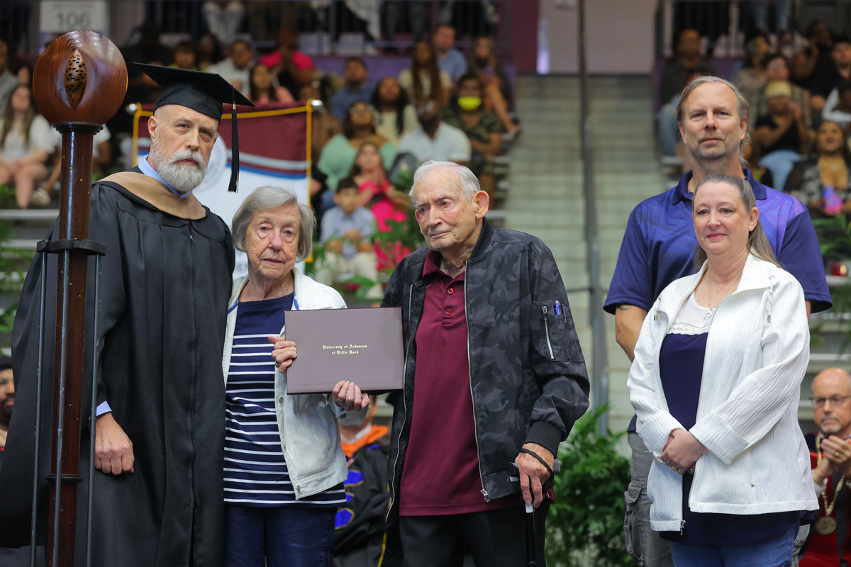 Tom Clifton, interim dean of the College of Business, Health, and Human Services, awards a posthumous degree to the family of Karen Stanley, an accounting student who passed away just two months before graduation. Stanley’s relatives include her parents, Jim and Betty Stanley, and sister and brother-in-law, Patti and Gene Downing.