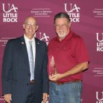 Jerry Ganz, vice chancellor for finance and administration, presents Dale Fonville of Mail Services with the Employee of the Year Award.