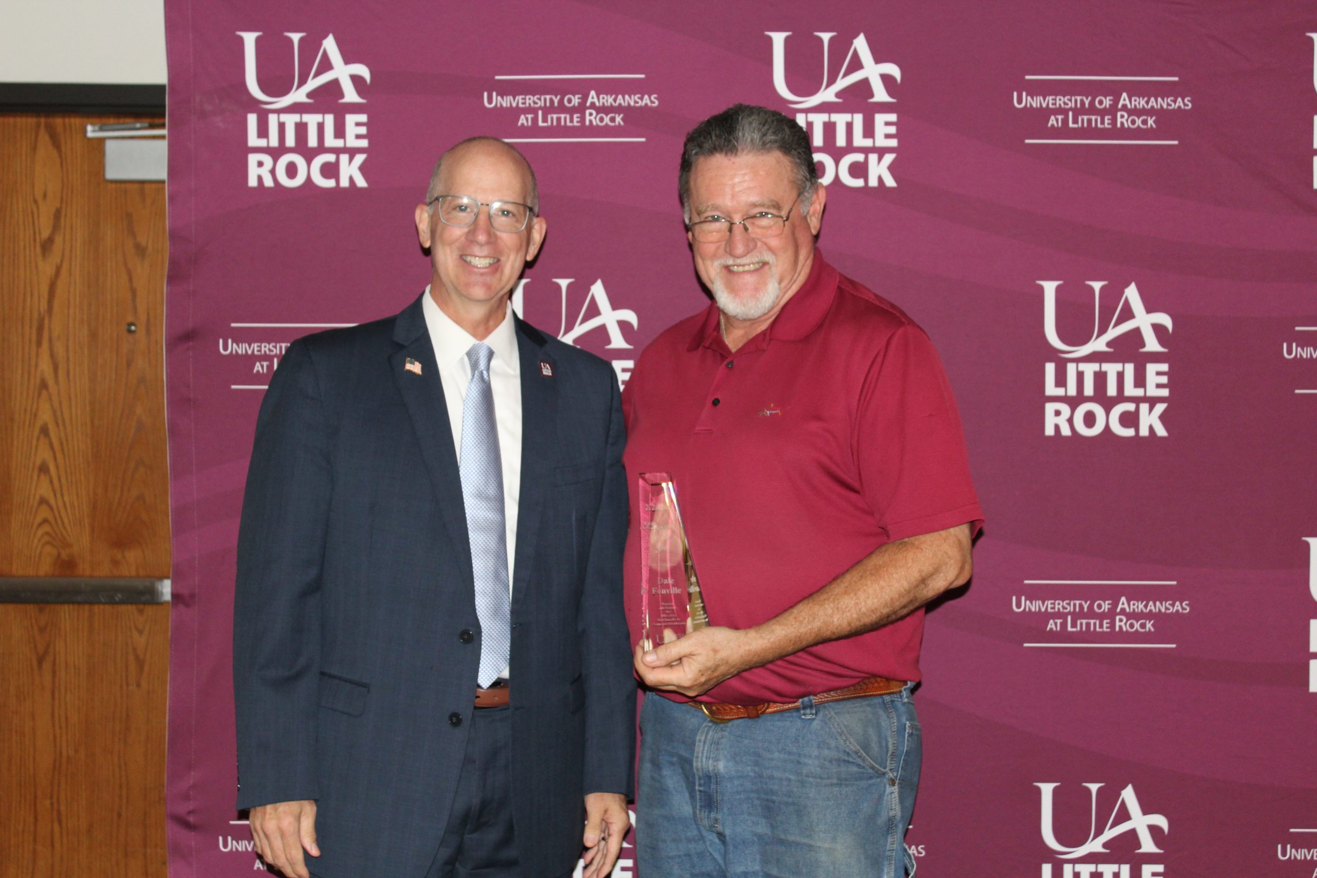 Jerry Ganz, vice chancellor for finance and administration, presents Dale Fonville of Mail Services with the Employee of the Year Award.