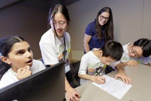 Windstream employee Sara Lary works with campers during the Windstream Girls Code camp at UA Little Rock.
Photo by Benjamin Krain.