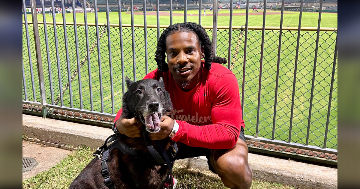 Avery Thomas-Wells takes his dog, Bruce Wayne, to an Arkansas Travelers game at Dickey Stephens.