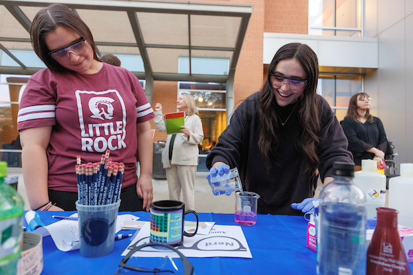 UA Little Rock students in the Donaghey College of STEM demonstrate to prospective students some of the science and technology experiments, research, and games they are working on during a Nerd Night. Photo by Benjamin Krain.