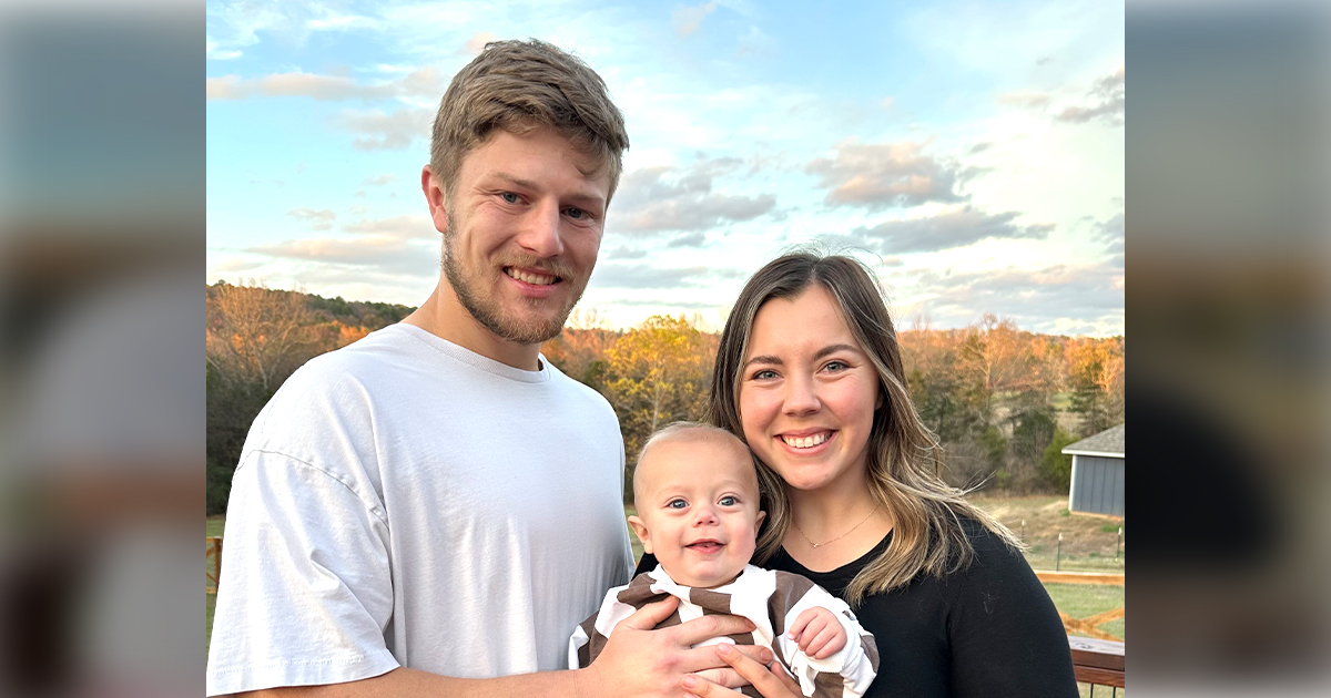 Graduate Spencer Massengale is shown with his wife and son Copeland.