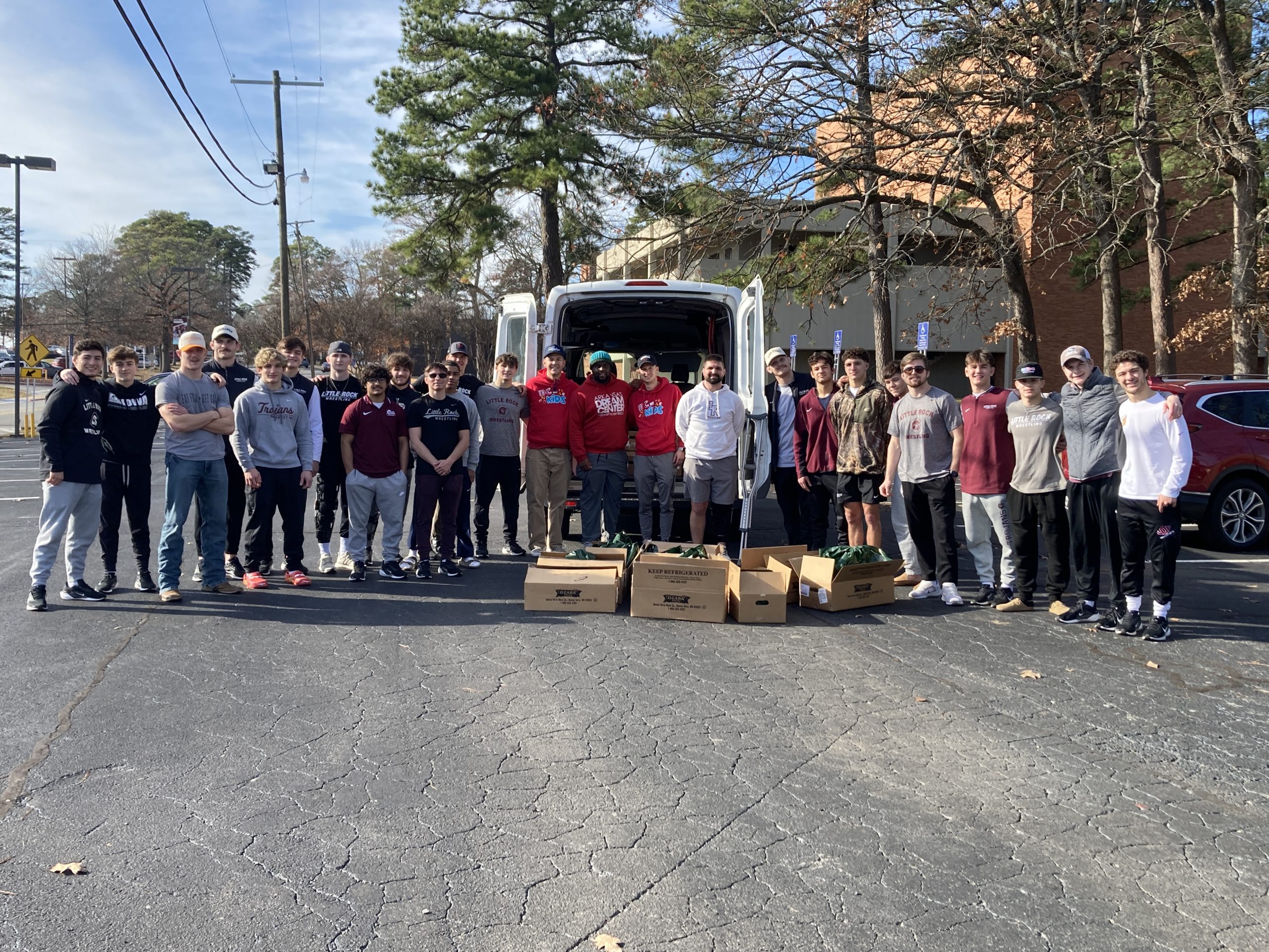 Members of the Little Rock Wrestling team loaded up about 250 hams that were donated to Every Arkansan to give to families in need in Central Arkansas. Photo by Angie Faller.