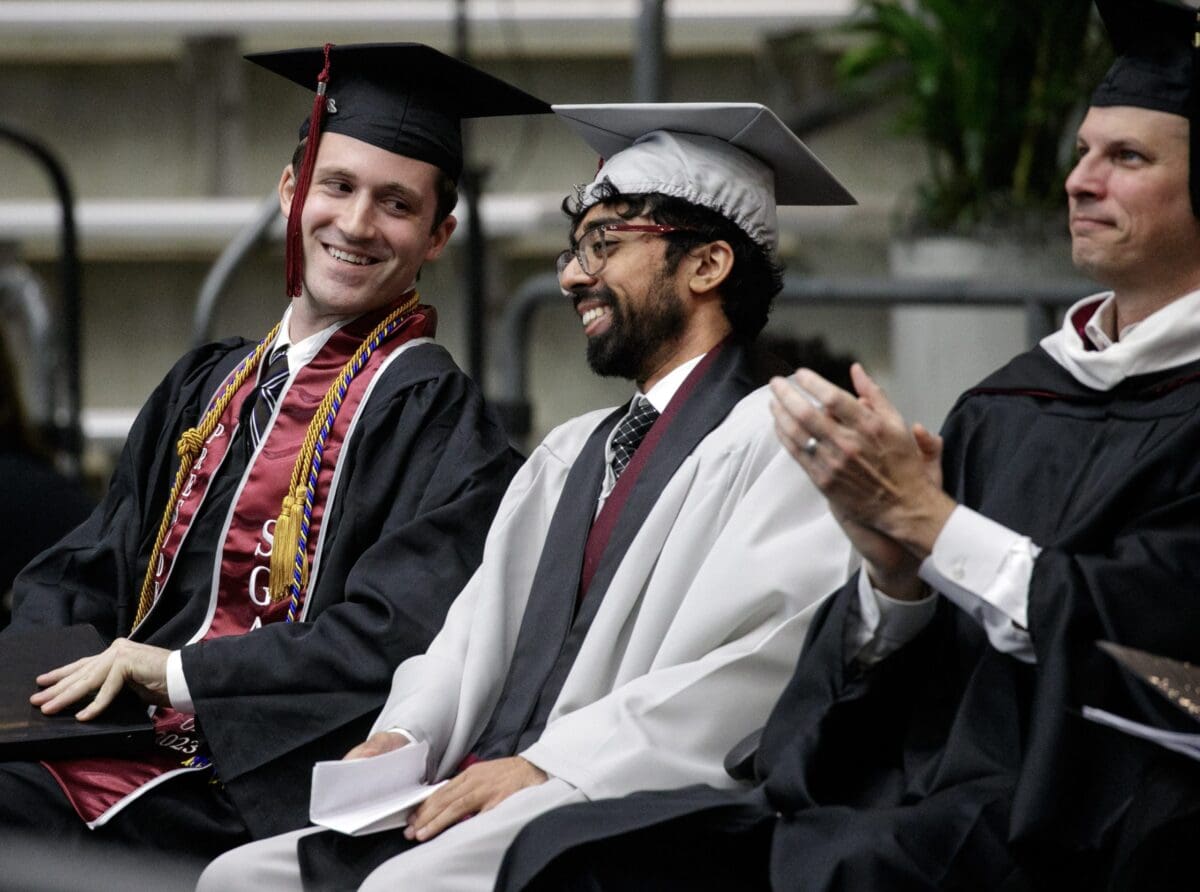 Thomas Forcum, left, sitting next to SGA Vice President Ahad Nadeem, right, at the Spring 2023 graduation ceremony.