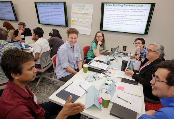 UA Little Rock teaching assistants and professors discuss active-learning techniques during the Mobile Institute on Scientific Teaching workshop on campus. Photo by Benjamin Krain.