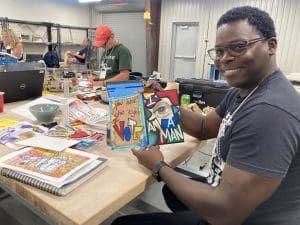 Cedric Granger, a native of West Memphis, Arkansas, shows off an art project he created while attended the AP Summer Institute at UA Little Rock.