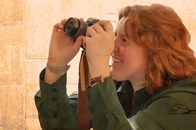 Candid photo of artist Y. Hope Osborn holding a camera.