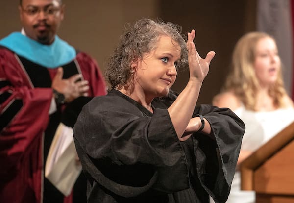 A sign language interpreter translates during a freshmen convocation event.