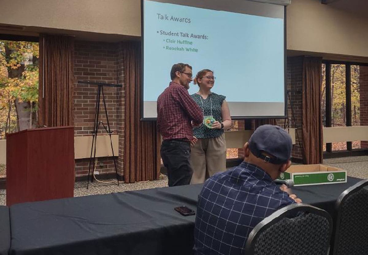 UA Little Rock student Rebekah White receives an award at the 49th Annual Midwest Southeast Photosynthesis Conference.