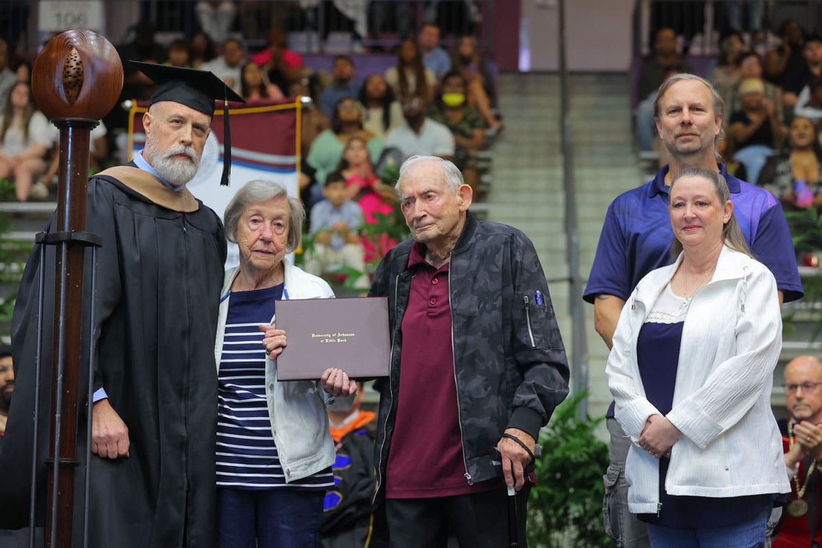 Tom Clifton, interim dean of the College of Business, Health, and Human Services, awards a posthumous degree to the family of Karen Stanley, an accounting student who passed away just two months before graduation. Stanley’s relatives include her parents, Jim and Betty Stanley, and sister and brother-in-law, Patti and Gene Downing.