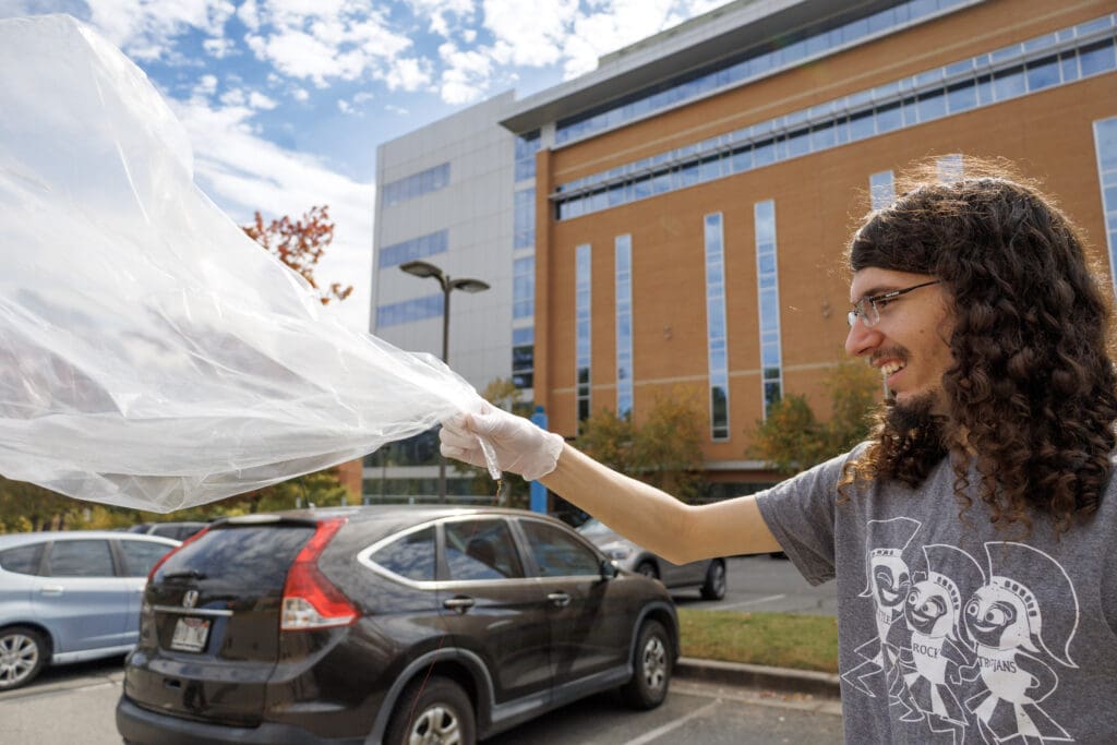 Will Fausel prepares to deploy a Pico balloon to see how far it can travel across the globe. Photo by Beatriz Garcia.