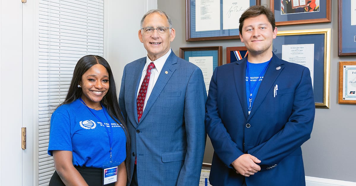 UA Little Rock student Joy Ferdinand, left, and Lake Dodson, right, a representative from Mississippi, visit with Sen. John Boozman, center, during the UNA-USA Advocacy Summit.