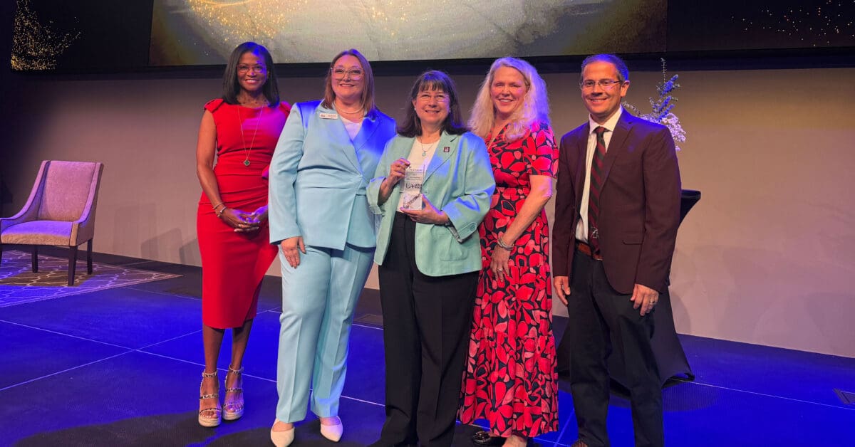 Chancellor Christina Drale, Provost Ann Bain, and Vice Chancellor Cody Decker accept the 2025 Outstanding Education Partner Award from the Arkansas Single Parent Scholarship Fund.
