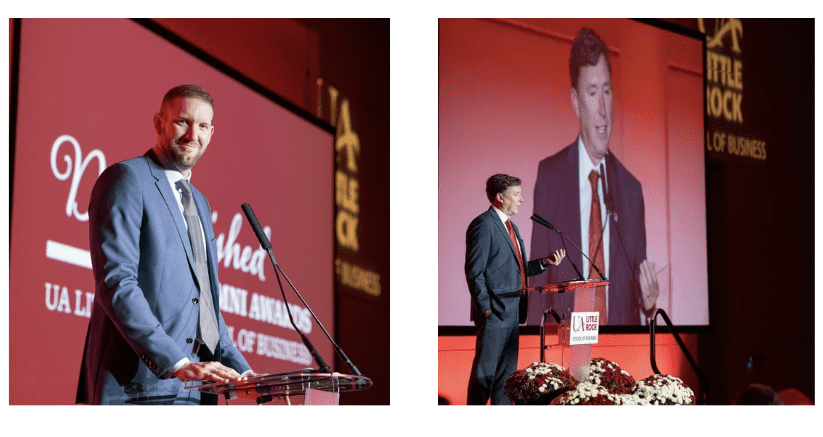 Two men speak during an awards ceremony.